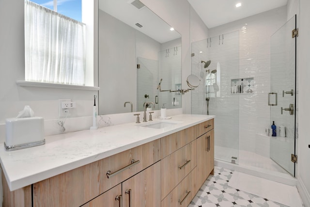 bathroom with vanity and a shower with shower door