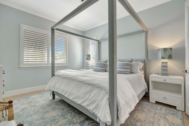 bedroom with ornamental molding and wood-type flooring