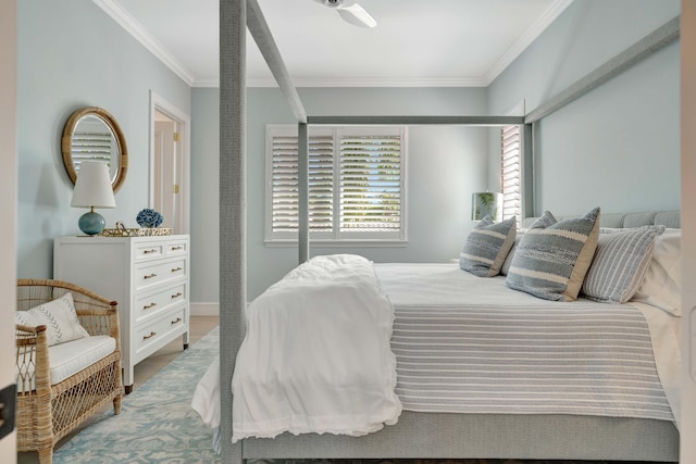 bedroom with hardwood / wood-style floors, ornamental molding, and ceiling fan