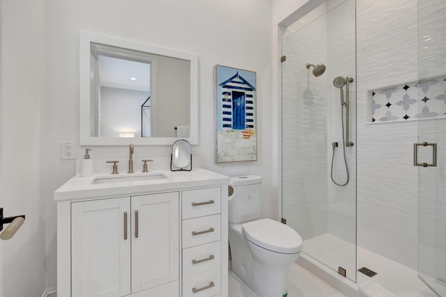 bathroom with vanity, a shower with shower door, and toilet