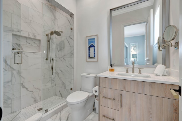 bathroom with an enclosed shower, vanity, ornamental molding, and toilet