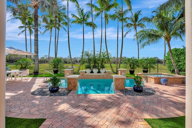 view of pool with an in ground hot tub and a patio