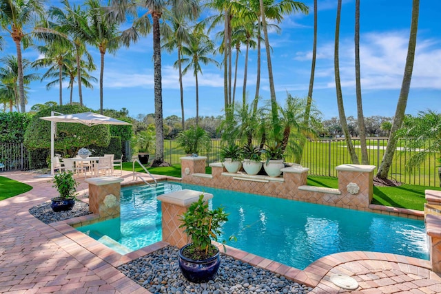 view of pool featuring a lawn and a patio area