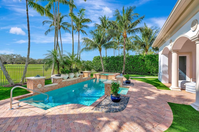 view of swimming pool featuring an in ground hot tub and a patio