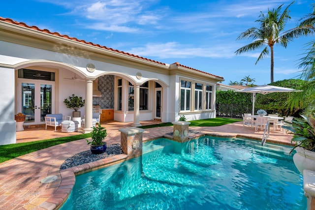 view of pool featuring french doors and a patio