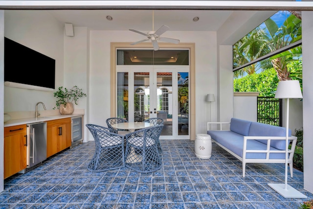 view of patio / terrace with ceiling fan, wine cooler, an outdoor hangout area, french doors, and an outdoor kitchen