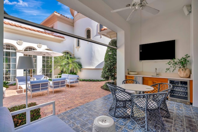 view of patio with wine cooler, an outdoor hangout area, ceiling fan, and an outdoor wet bar