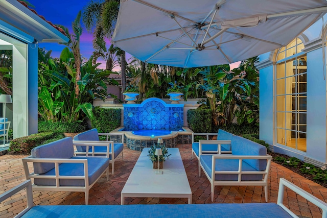 patio terrace at dusk featuring outdoor lounge area