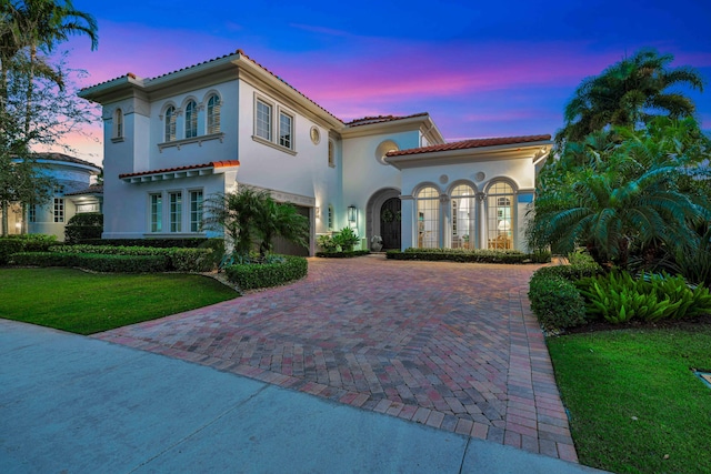 mediterranean / spanish-style house featuring a lawn