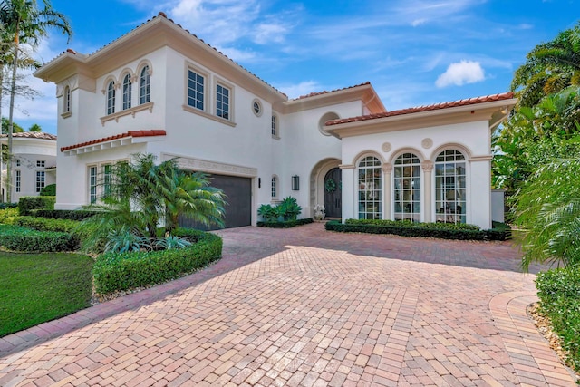 mediterranean / spanish-style home with a garage