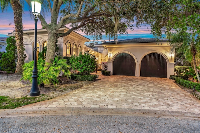 mediterranean / spanish-style home featuring a garage