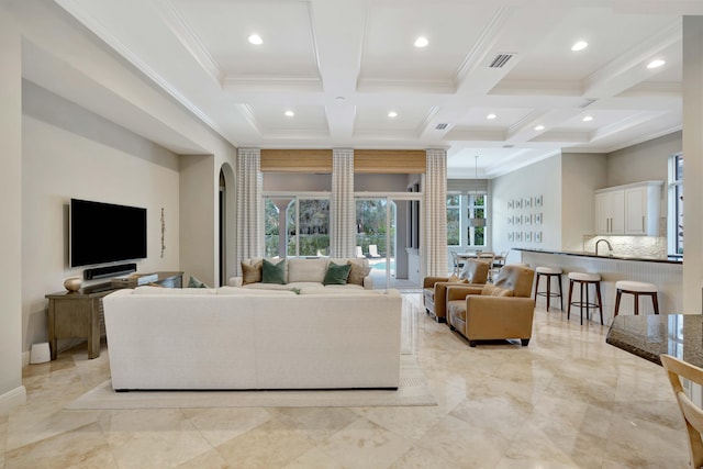 living room with beamed ceiling, crown molding, and coffered ceiling