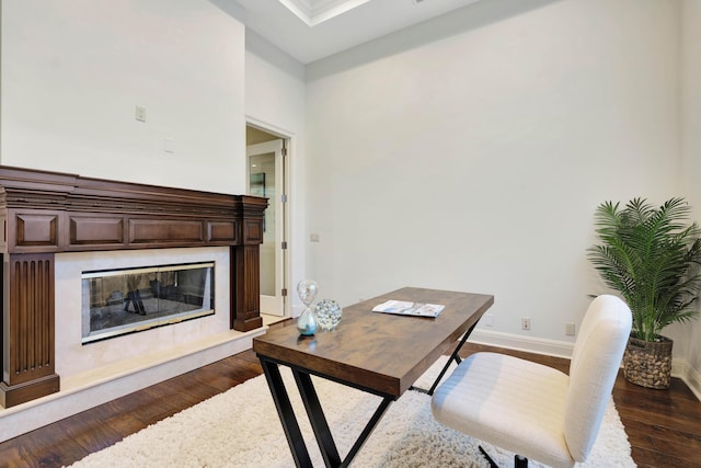 office space featuring dark hardwood / wood-style flooring and a high end fireplace