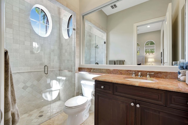 bathroom featuring vanity, a shower with door, and toilet