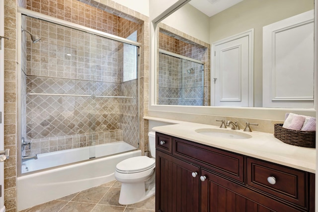 full bathroom with vanity, tile patterned flooring, shower / bath combination with glass door, and toilet