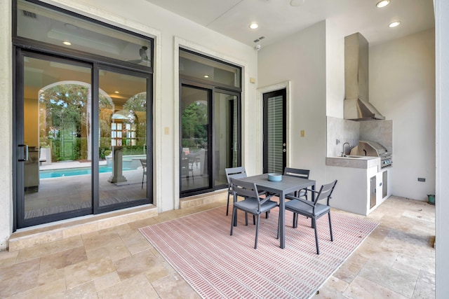 view of patio / terrace featuring an outdoor kitchen and a grill