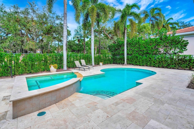 view of swimming pool featuring a patio and an in ground hot tub