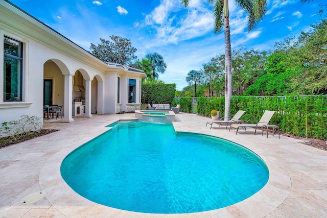 view of swimming pool with an in ground hot tub and a patio area