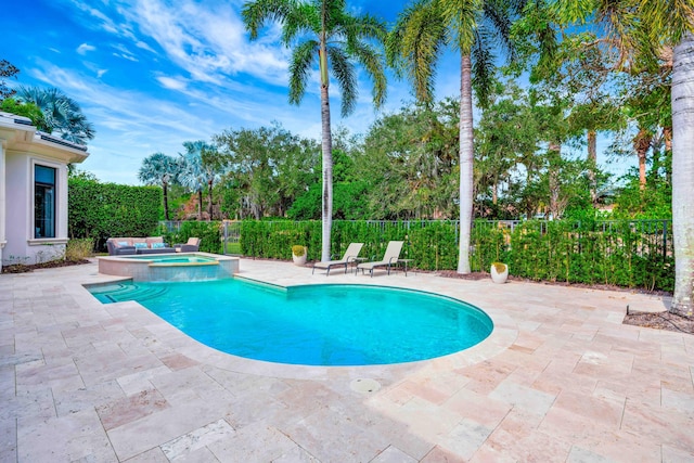 view of pool featuring a patio and an in ground hot tub