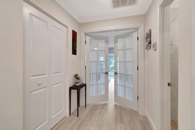 doorway featuring french doors and light hardwood / wood-style flooring