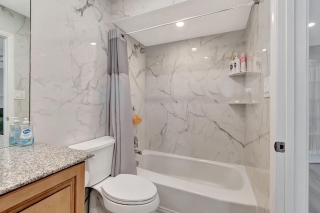 full bathroom featuring shower / tub combo with curtain, vanity, toilet, and tile walls