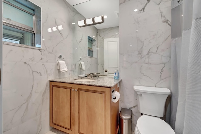 bathroom featuring tile walls, vanity, curtained shower, and toilet