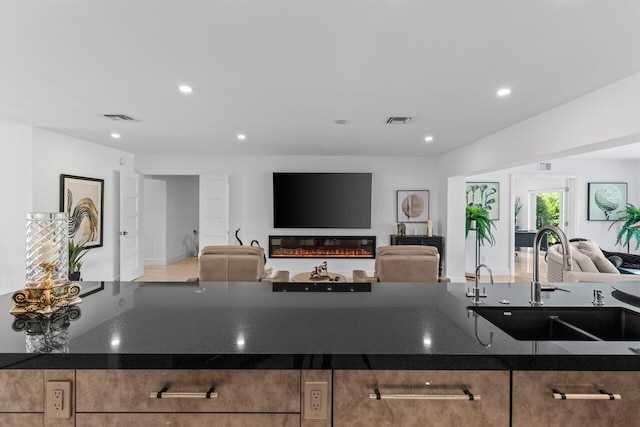 11955 N Lake Dr, Boynton Beach, FL 33436 - kitchen featuring sink and dark stone countertops