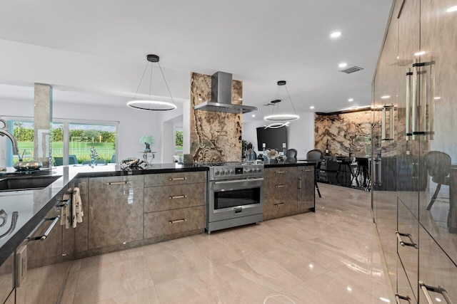 11955 N Lake Dr, Boynton Beach, FL 33436 - kitchen with pendant lighting, high end range, sink, and wall chimney range hood
