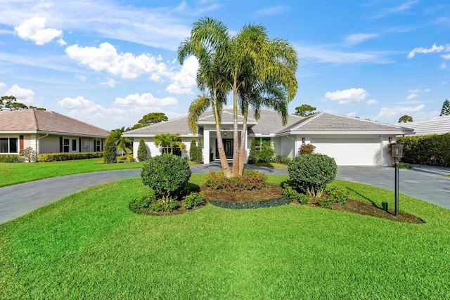 ranch-style house with a garage and a front yard