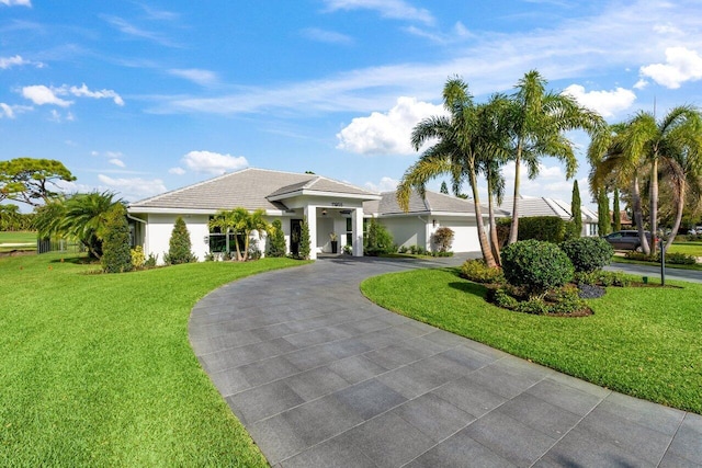11955 N Lake Dr, Boynton Beach, FL 33436 - view of front of home featuring a garage and a front lawn
