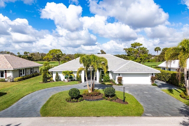 11955 N Lake Dr, Boynton Beach, FL 33436 - view of front of home featuring a garage and a front yard