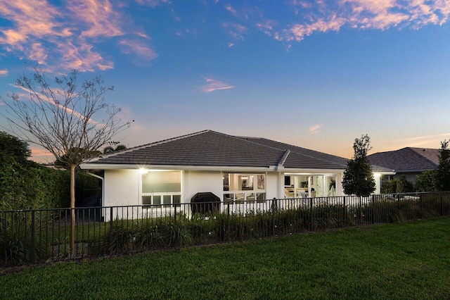 11955 N Lake Dr, Boynton Beach, FL 33436 - back house at dusk with a yard
