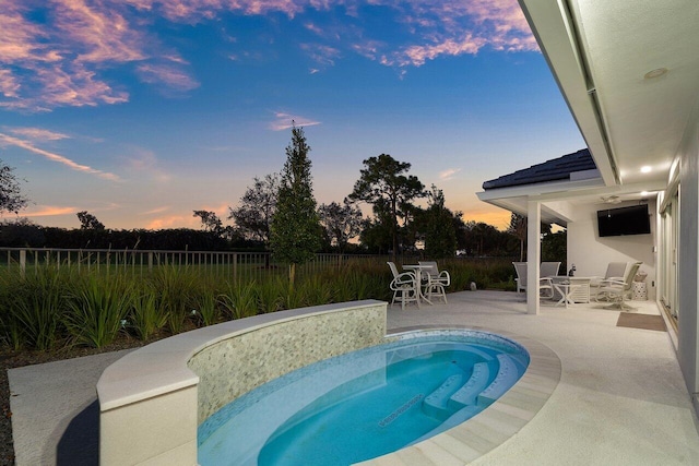 11955 N Lake Dr, Boynton Beach, FL 33436 - pool at dusk featuring a patio