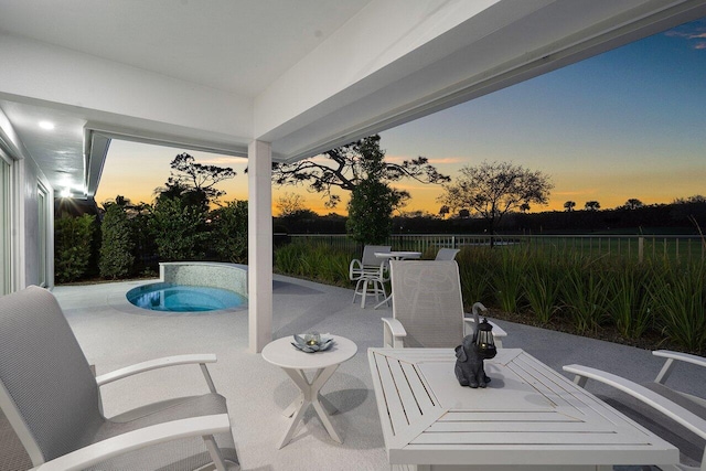 11955 N Lake Dr, Boynton Beach, FL 33436 - patio terrace at dusk with a pool