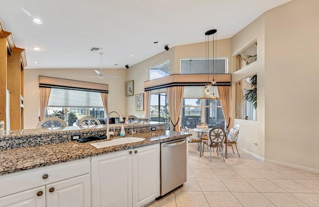 kitchen with sink, dishwasher, pendant lighting, dark stone counters, and white cabinets