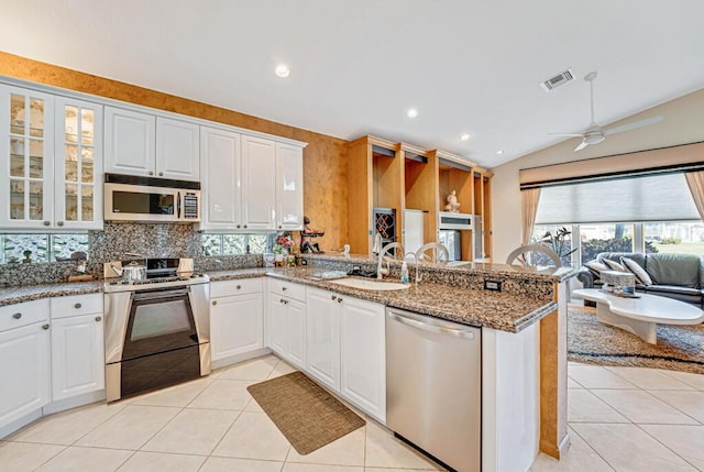 kitchen featuring stainless steel appliances, white cabinets, and kitchen peninsula