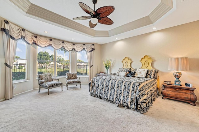 bedroom with crown molding, carpet floors, and a raised ceiling