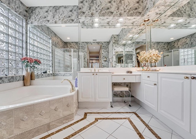 bathroom with vanity and separate shower and tub