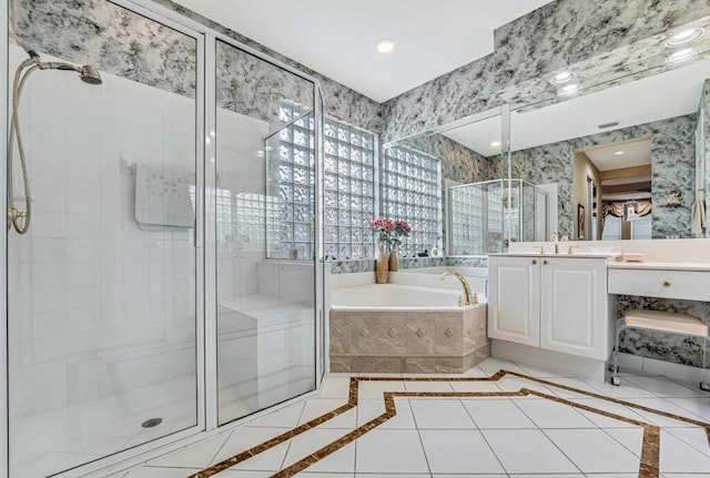 bathroom featuring independent shower and bath, vanity, and tile patterned floors