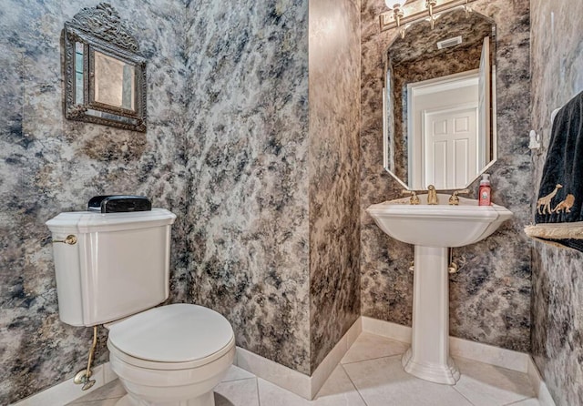 bathroom featuring tile patterned flooring and toilet