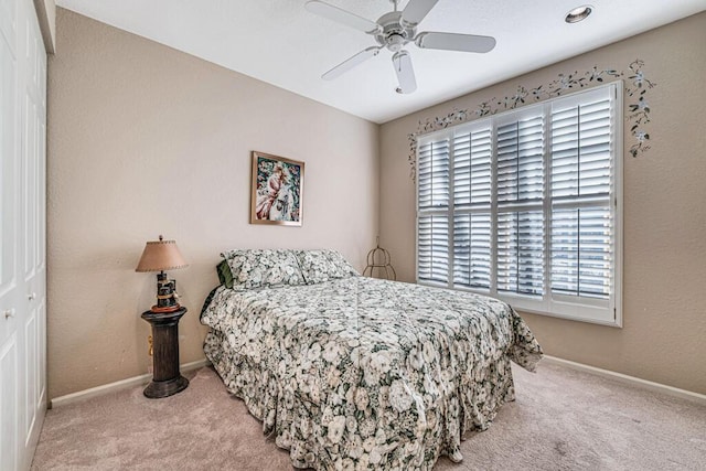 carpeted bedroom with ceiling fan