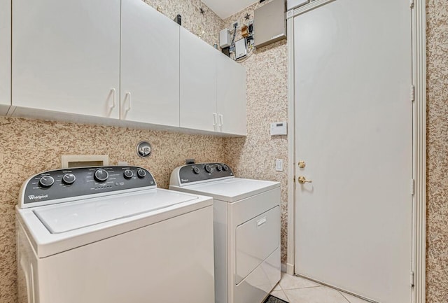 washroom with cabinets, light tile patterned flooring, and separate washer and dryer