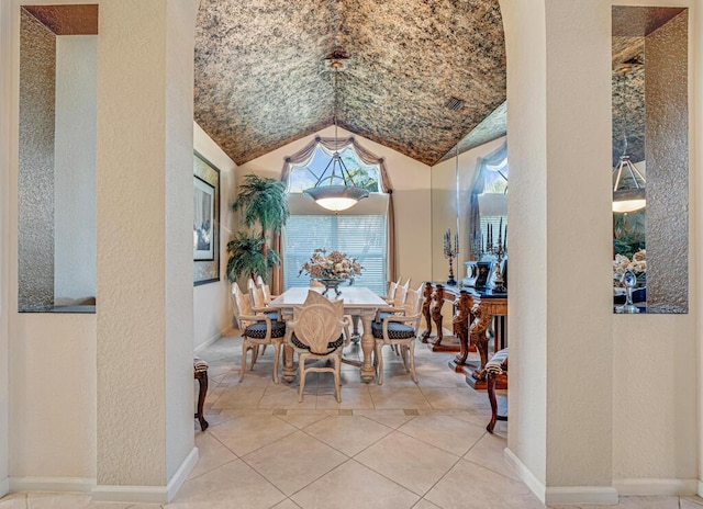 dining room with lofted ceiling and tile patterned flooring