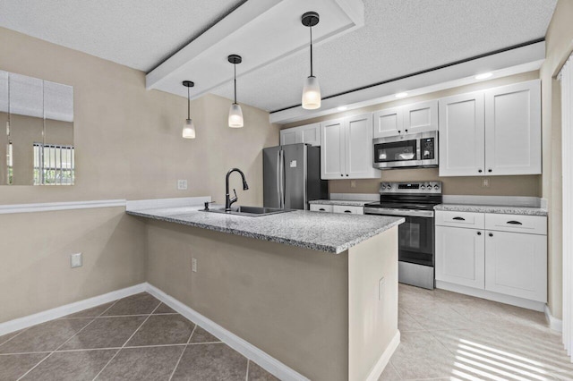 kitchen with stainless steel appliances, white cabinets, and kitchen peninsula