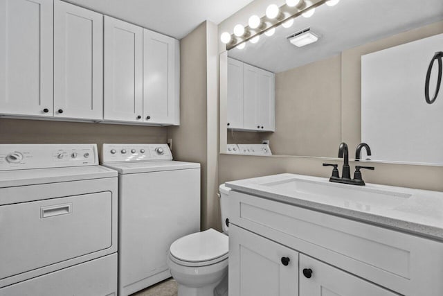 bathroom featuring vanity, toilet, and separate washer and dryer