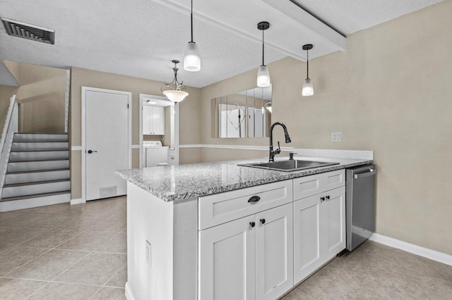 kitchen featuring sink, white cabinetry, decorative light fixtures, stainless steel dishwasher, and light stone countertops