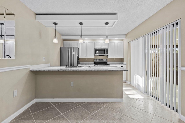 kitchen featuring white cabinetry, pendant lighting, stainless steel appliances, and kitchen peninsula