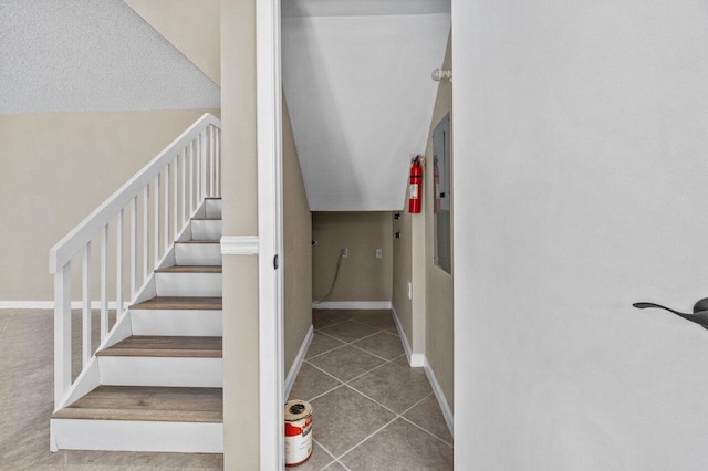 stairs featuring tile patterned flooring