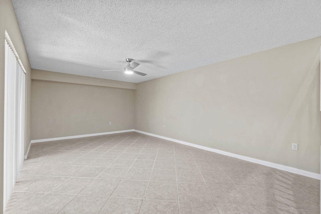 spare room with a textured ceiling and ceiling fan