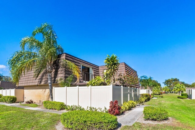 view of side of home with a lawn